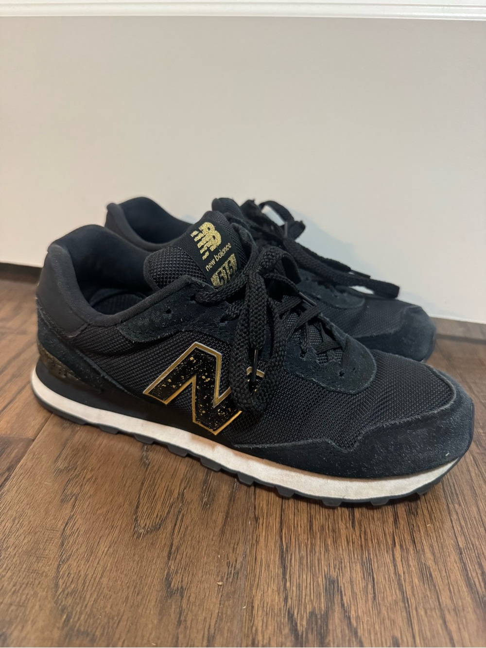 New Balance Black Sneakers with Gold Logo Accents